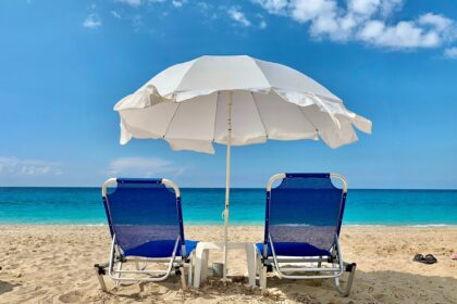 Lege stoelen met een parasol op het strand